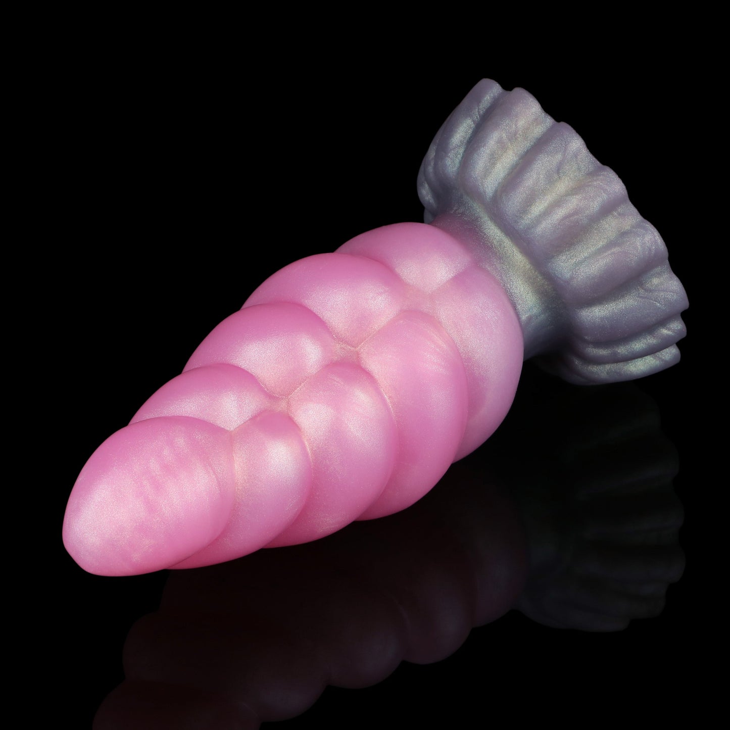 Larval the Alien Spawn dildo, Lick colorway, lying on its side in full profile with the suction base to the right
