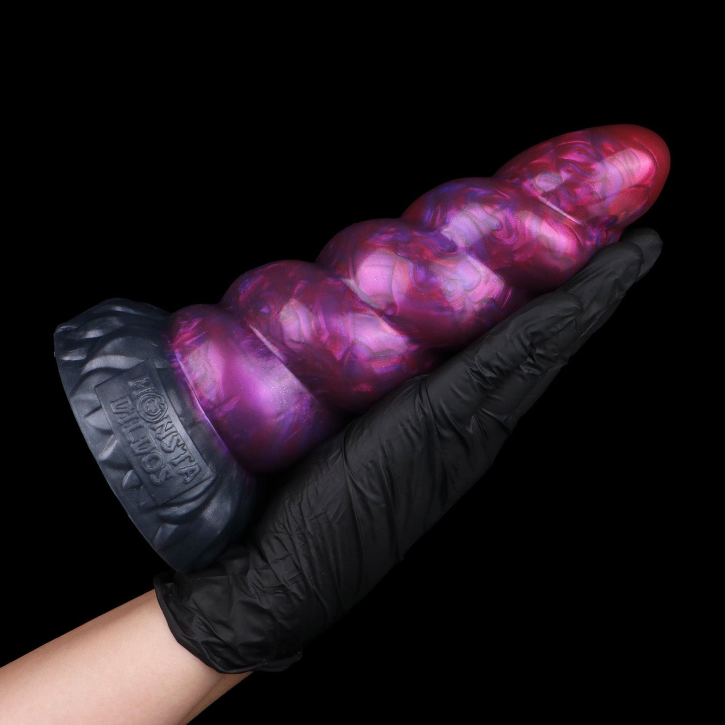Alicorn the Unicorn dildo, Adrenaline colorway, held in hand for size reference