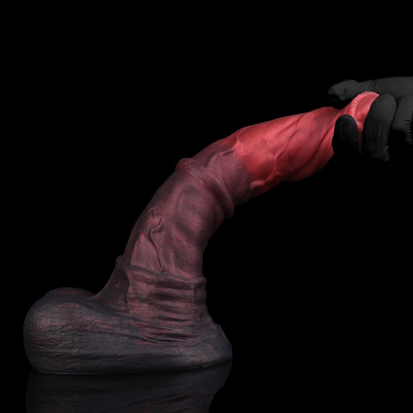 Atlas the Celestial Stallion dildo, Dusk colorway, held in hand demonstrating bend