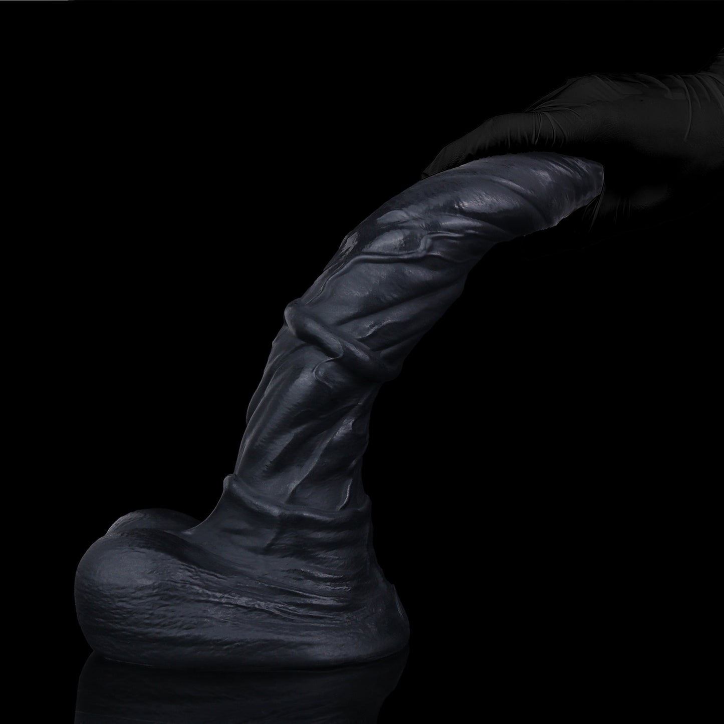 Atlas the Celestial Stallion dildo, Shadow colorway, held in hand showing flexibility