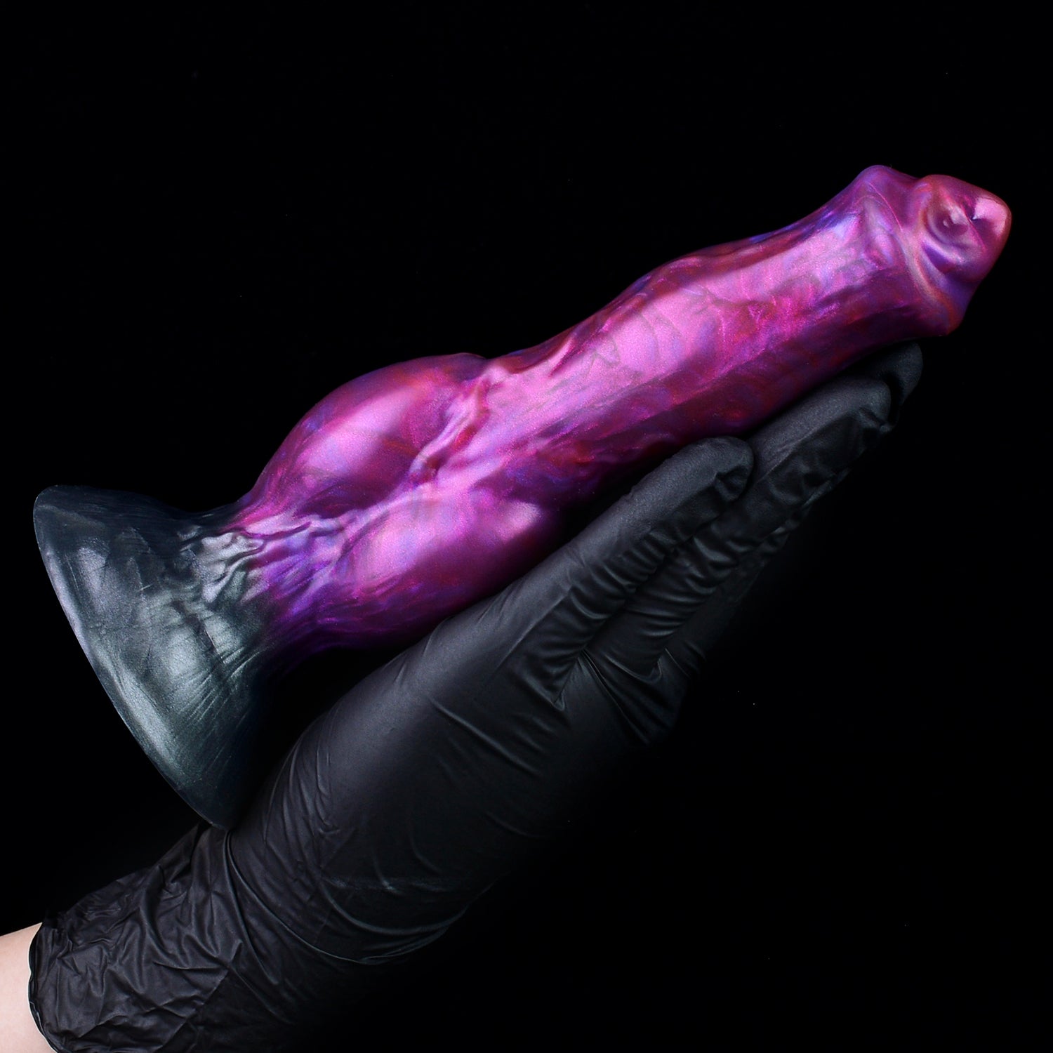 Darkhound the Canine Alpha dildo, Adrenaline colorway, held in a gloved hand at an angle showing the full length of the shaft