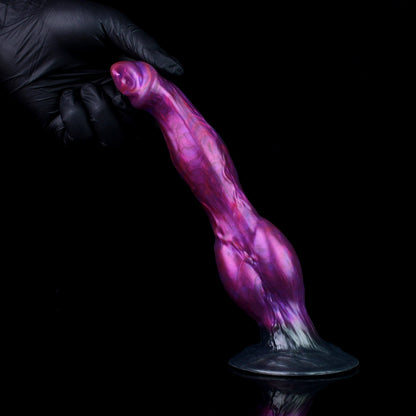Darkhound the Canine Alpha dildo, Adrenaline colorway, standing on its base with a gloved hand steadying the tip