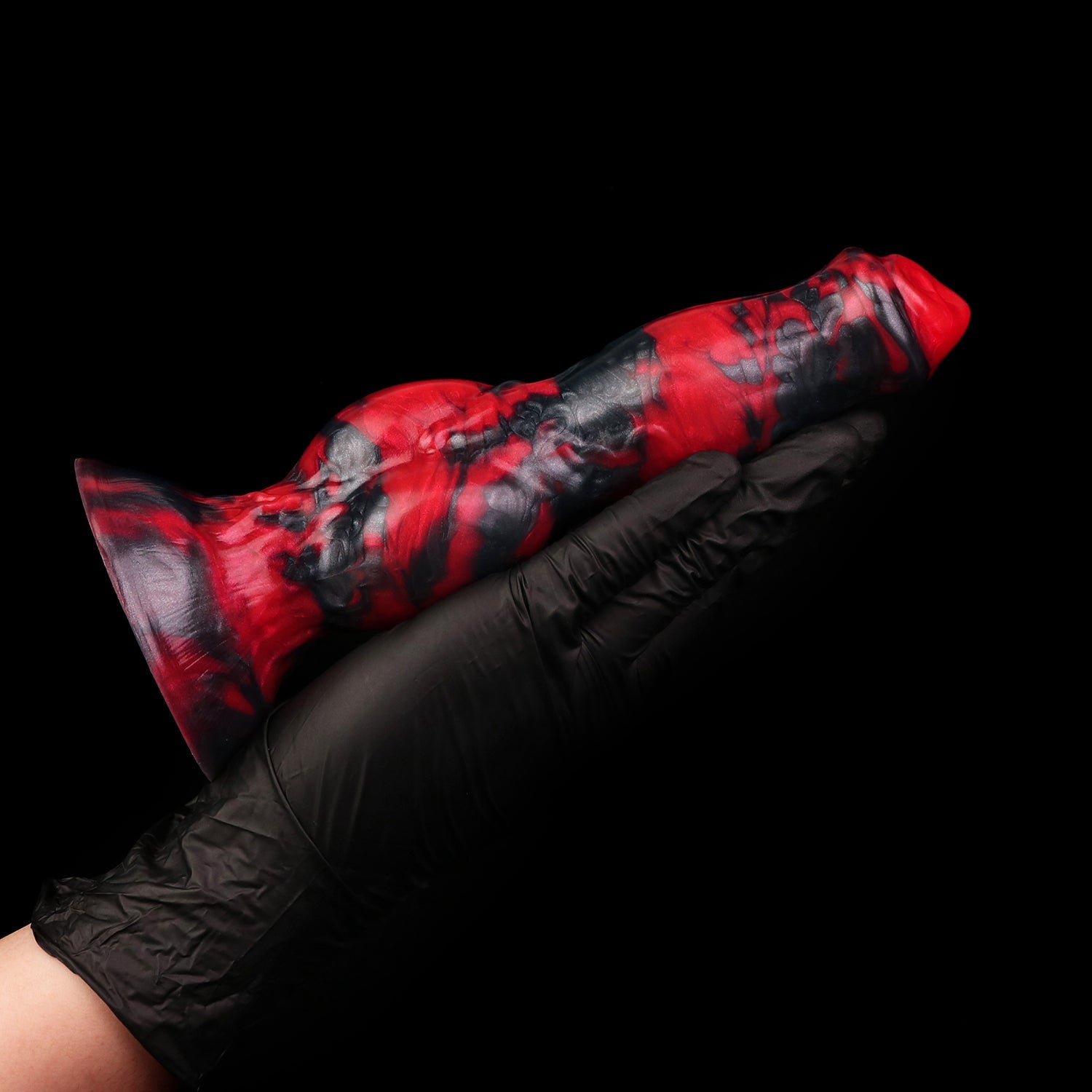 Darkhound the Canine Alpha dildo, Havoc colorway, held in a gloved hand, side view showing the full length