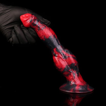 Darkhound the Canine Alpha dildo, Havoc colorway, standing on its base with a gloved hand steadying the tip
