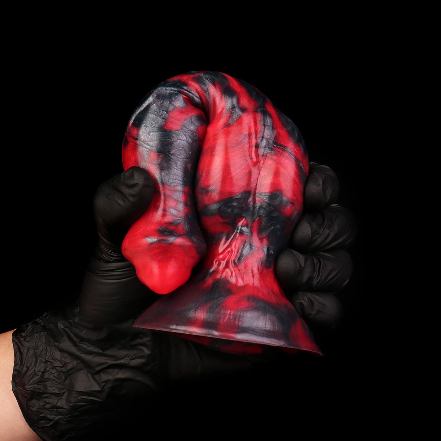 Darkhound the Canine Alpha dildo, Havoc colorway, gloved hand gripping the pronounced canine knot