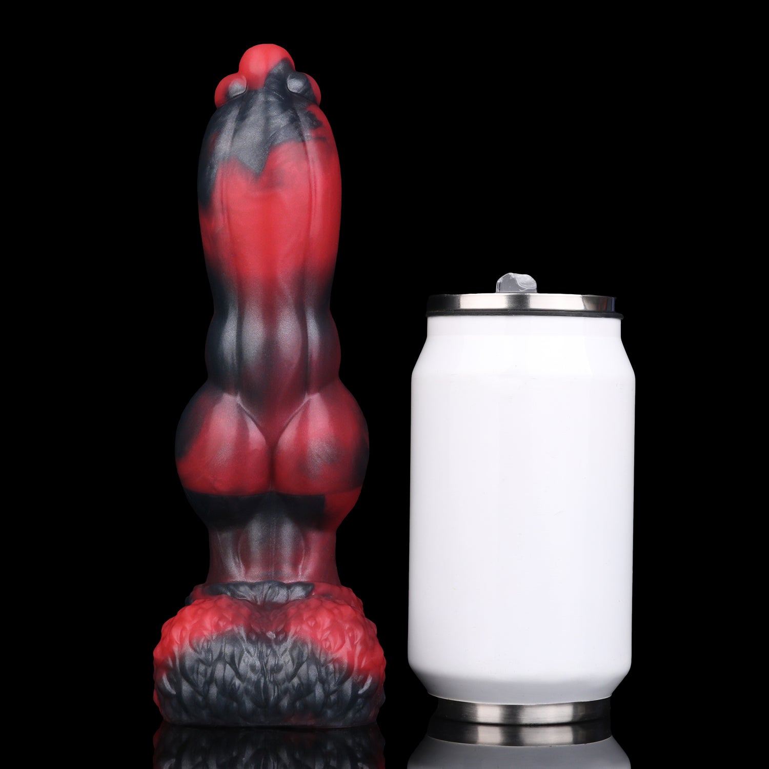 Evren the Moonfang dildo, Havoc colorway, standing upright beside a soda can for size comparison