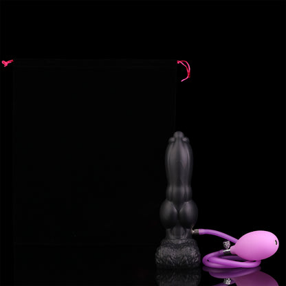 Evren the Moonfang dildo, Shadow colorway, shown with the included hand pump connected for inflating the shaft