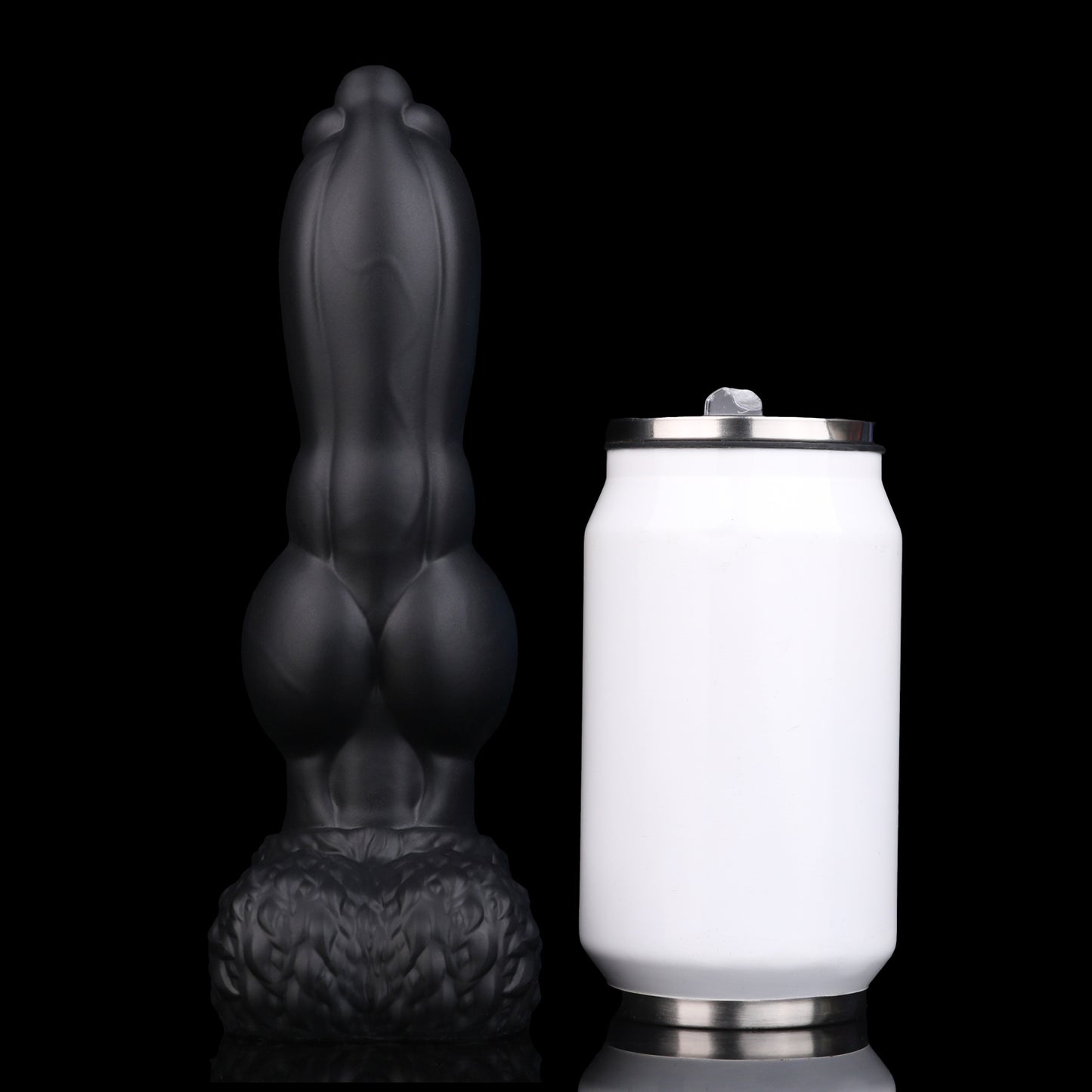 Evren the Moonfang dildo, Shadow colorway, standing upright beside a soda can for size comparison