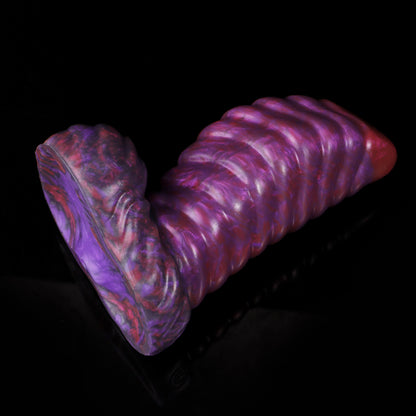 Kael the Dragonkin dildo, Adrenaline colorway, resting at an angle showing the full length of the segmented shaft