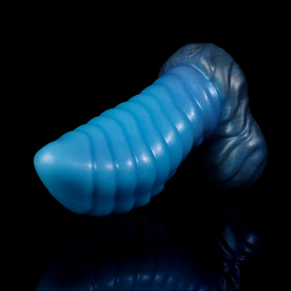 Kael the Dragonkin dildo, Arctic colorway, lying on its side in full profile showing the segmented shaft and scale-textured base
