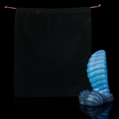 Kael the Dragonkin dildo, Arctic colorway, shown alongside the included black Lunara's Realm storage pouch