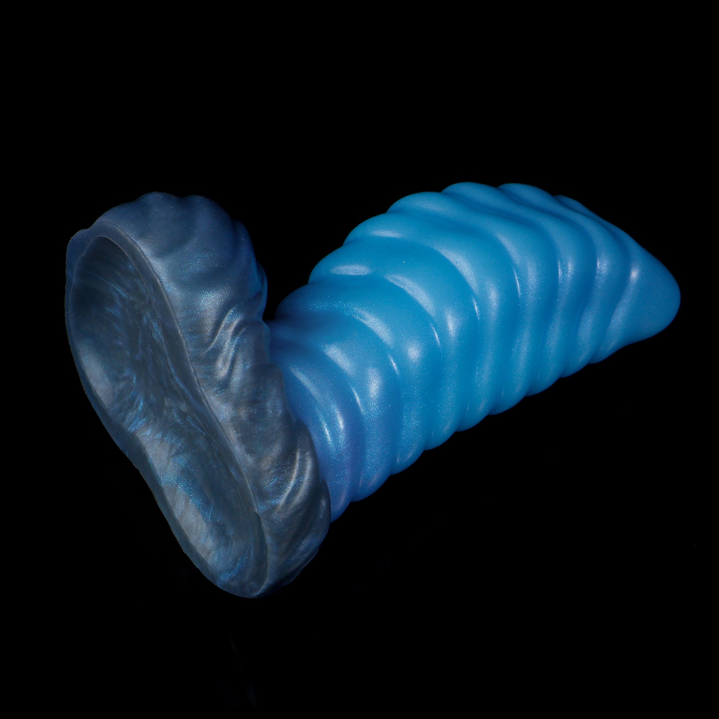 Kael the Dragonkin dildo, Arctic colorway, tilted to show the underside of the scale-textured suction base