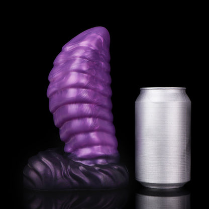 Kael the Dragonkin dildo, Grape colorway, standing upright beside a soda can for size comparison