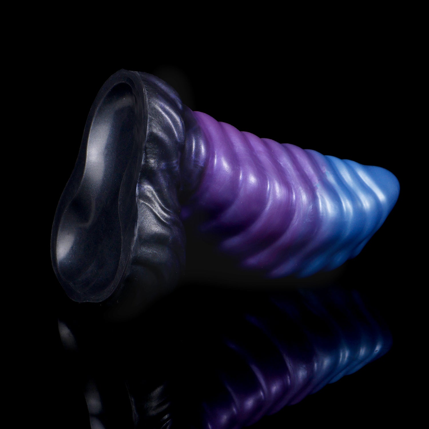 Kael the Dragonkin dildo, Spectre colorway, tilted to show the underside of the scale-textured suction base