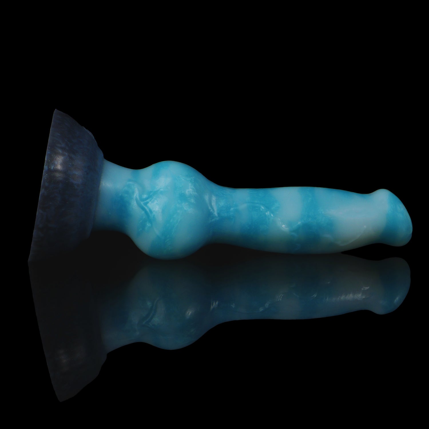 Koda the Guardian dildo, Blizzard colorway, lying on its side with the rounded suction base facing the camera