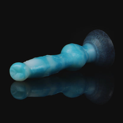 Koda the Guardian dildo, Blizzard colorway, lying on its side in full profile showing the veined shaft and knot