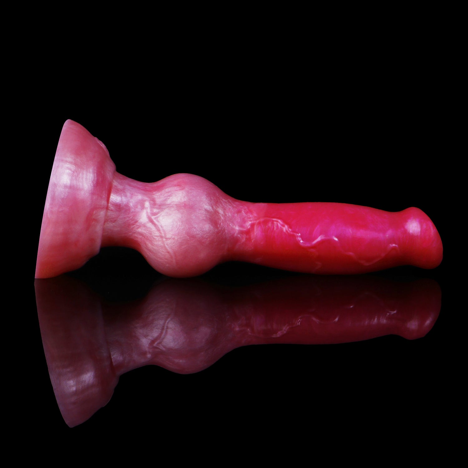 Koda the Guardian dildo, Blush colorway, lying on its side showing the full length of the veined shaft