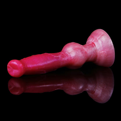 Koda the Guardian dildo, Blush colorway, lying on its side in profile showing the tapered head and knot