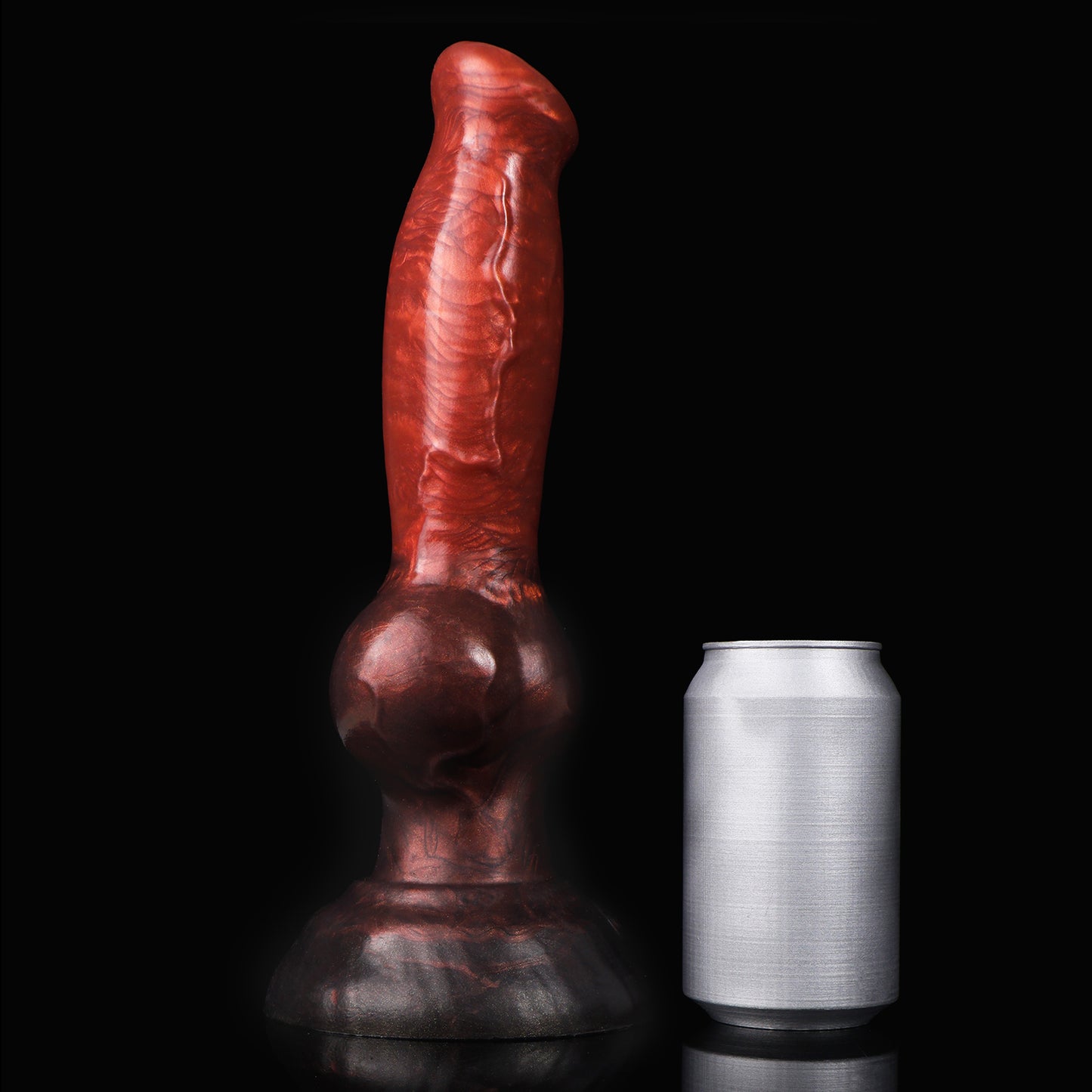 Koda the Guardian dildo, Lava colorway, standing upright beside a soda can for size comparison