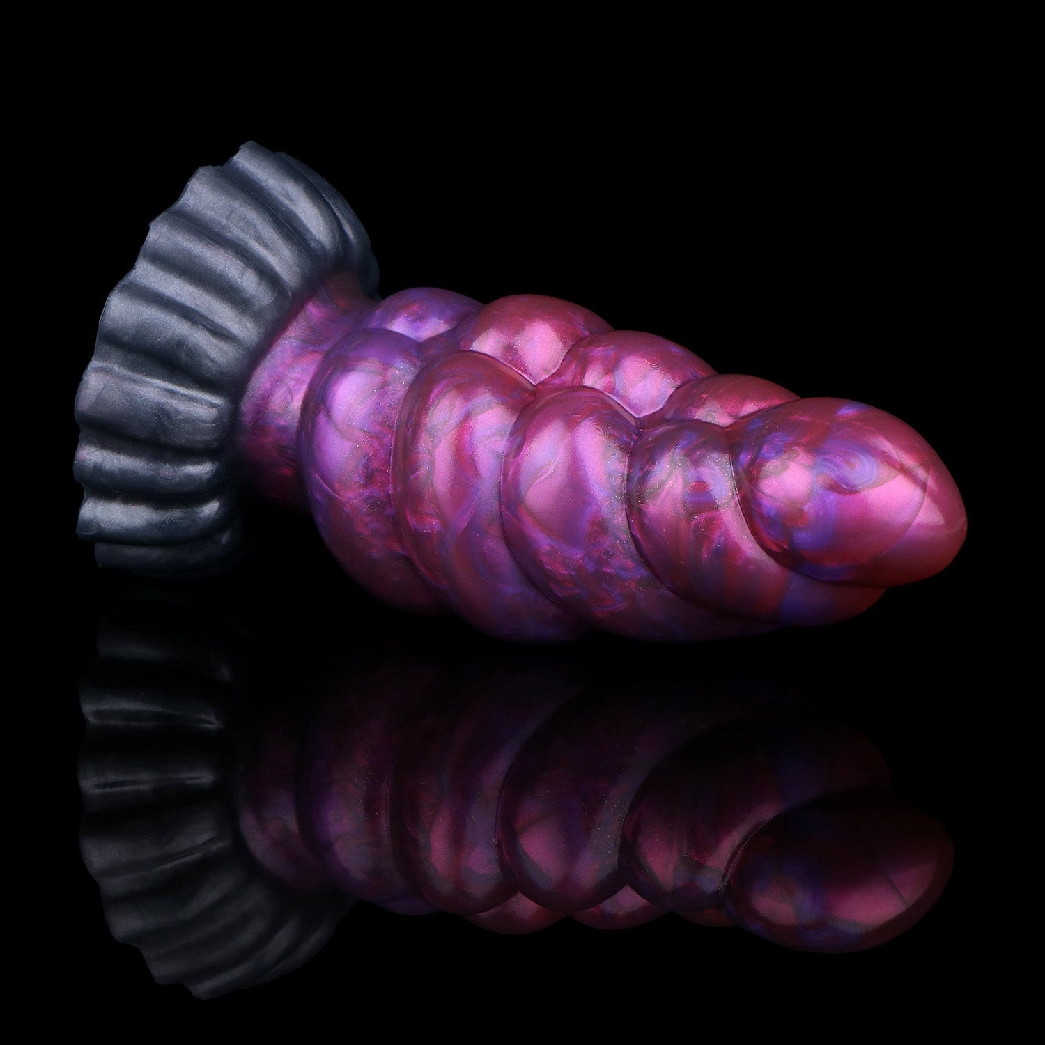 Larval the Alien Spawn dildo, Adrenaline colorway, lying on its side showing the gunmetal base surging into metallic purple and crimson