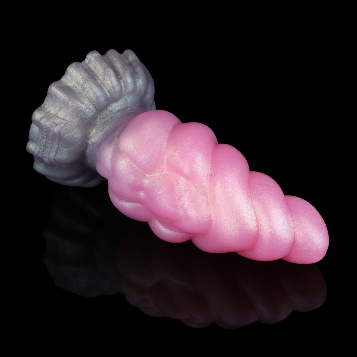 Larval the Alien Spawn dildo, Lick colorway, lying on its side showing the metallic grey base transitioning into shimmering cotton-candy pink