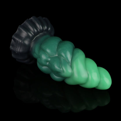 Larval the Alien Spawn dildo, Ogre colorway, lying on its side showing the midnight olive base rising into layered dark and vibrant greens