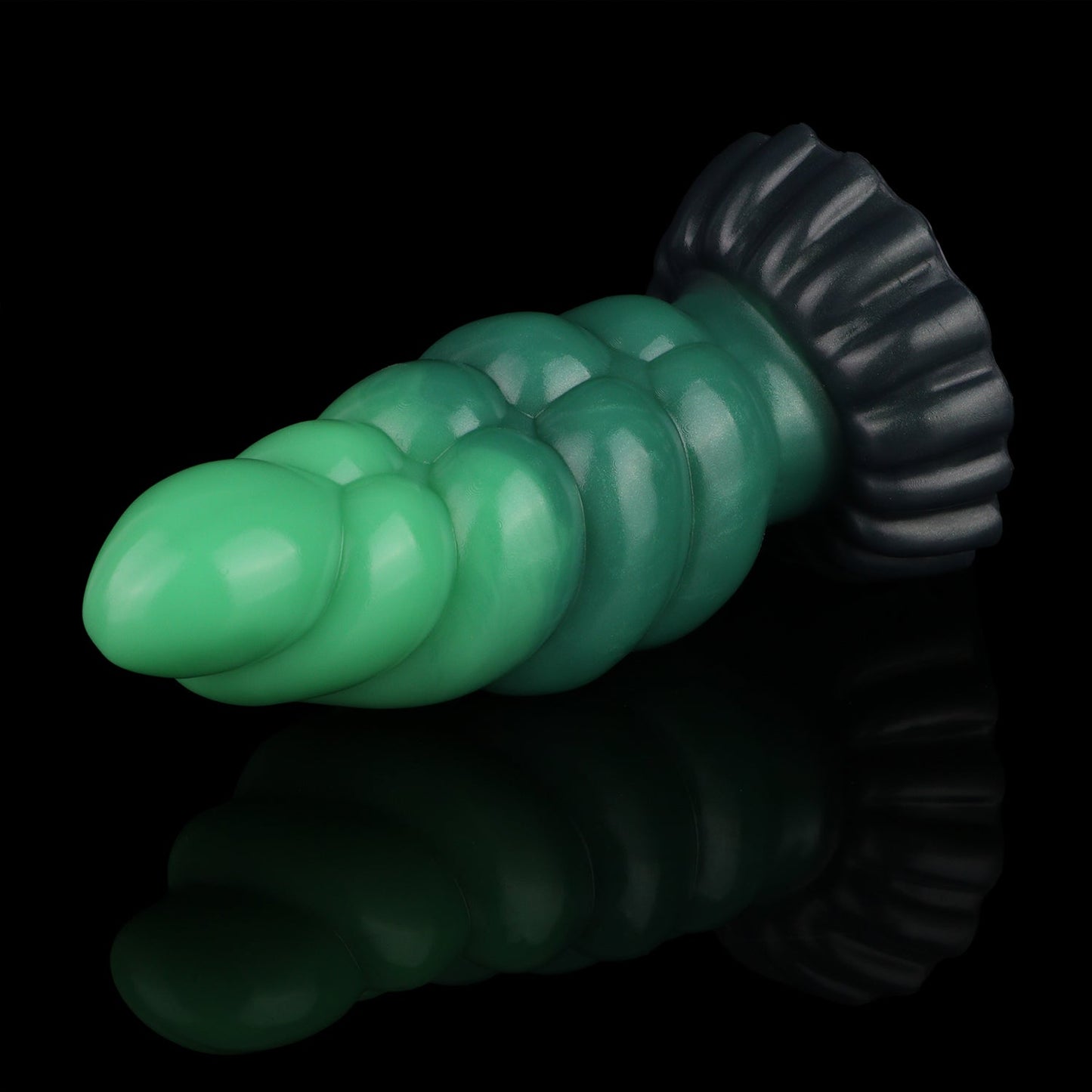 Larval the Alien Spawn dildo, Ogre colorway, lying at an angle showing the segmented shaft and midnight olive base