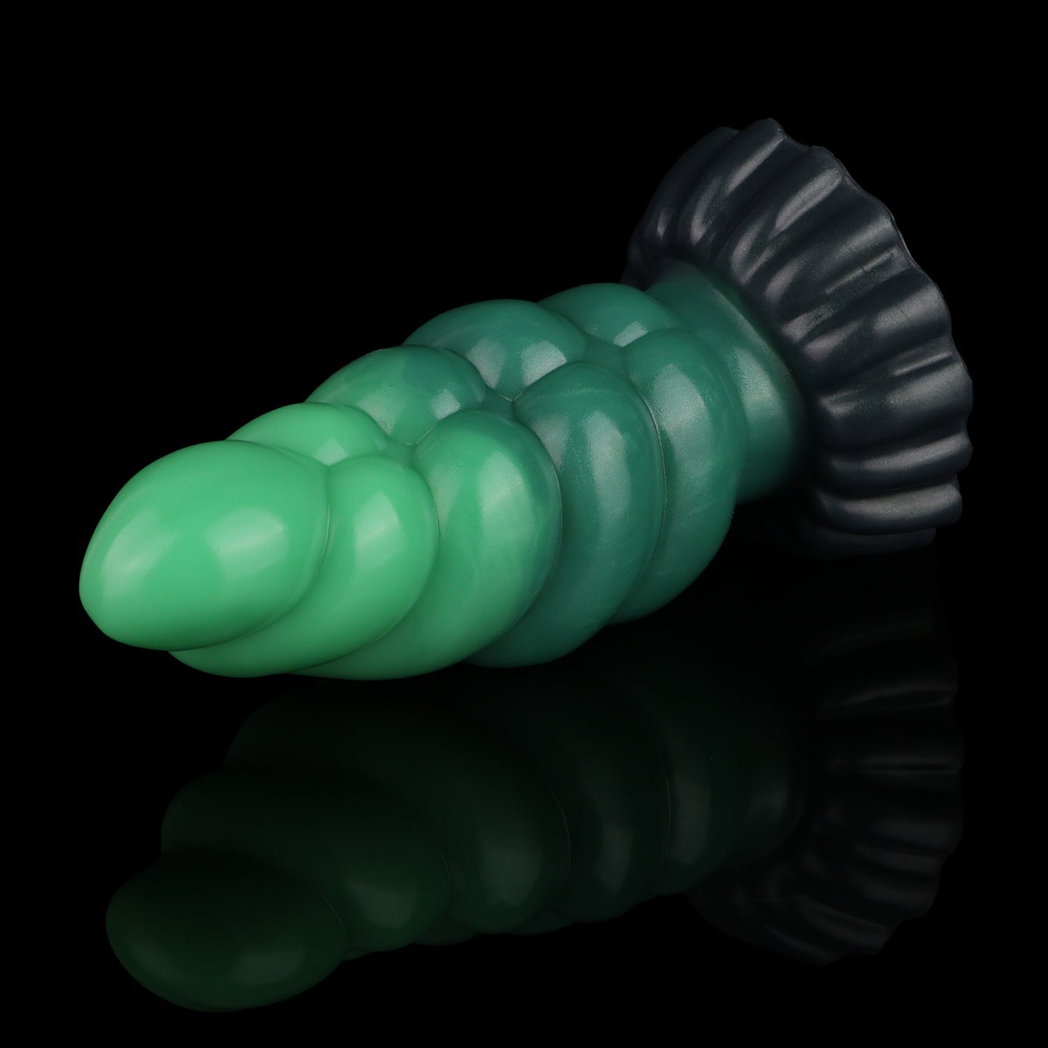 Larval the Alien Spawn dildo, Ogre colorway, lying at an angle showing the segmented shaft and midnight olive base