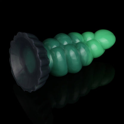Larval the Alien Spawn dildo, Ogre colorway, tilted to show the broad round suction cup base