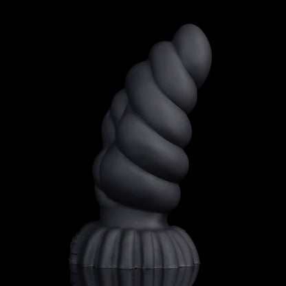 Larval the Alien Spawn dildo, Shadow colorway, standing upright on its ribbed round base showing the curved, segmented shaft