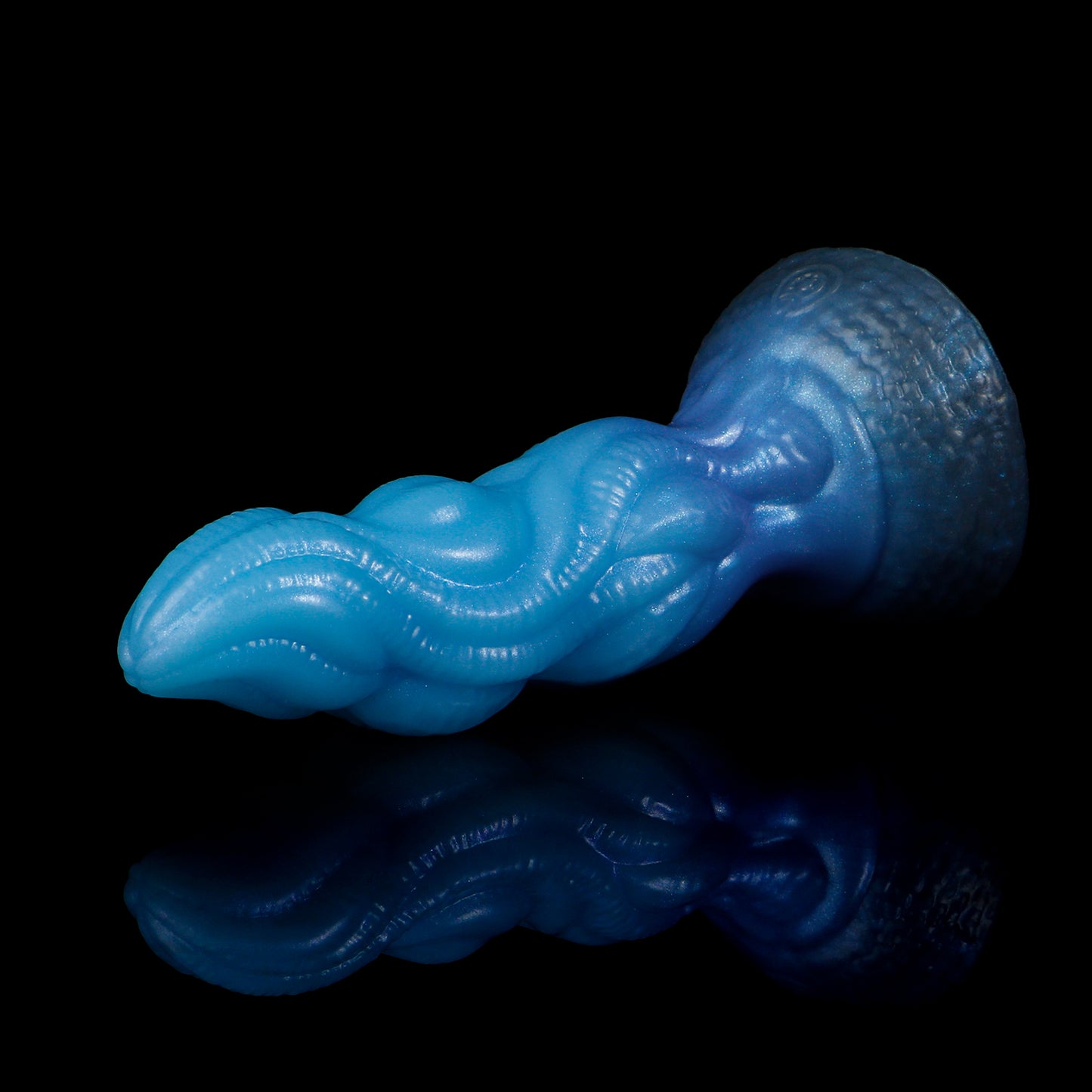 Lumen the Bloomborn dildo, Arctic colorway, lying on its side in full profile showing the tentacle-like shaft