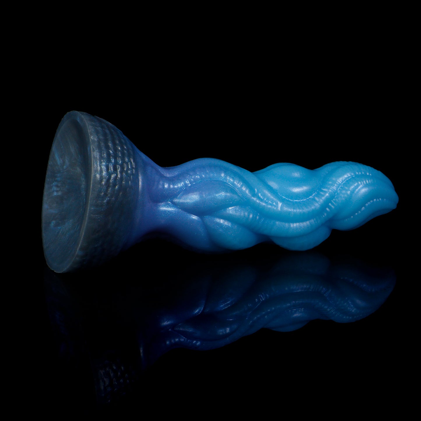 Lumen the Bloomborn dildo, Arctic colorway, tilted to show the broad darkened suction-cup base