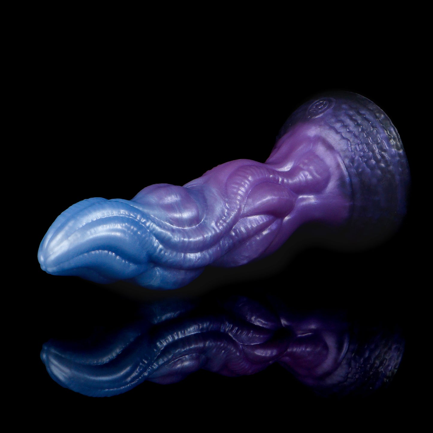 Lumen the Bloomborn dildo, Spectre colorway, lying on its side in full profile showing the tentacle-like shaft