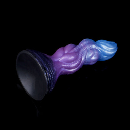 Lumen the Bloomborn dildo, Spectre colorway, tilted to show the broad darkened suction-cup base