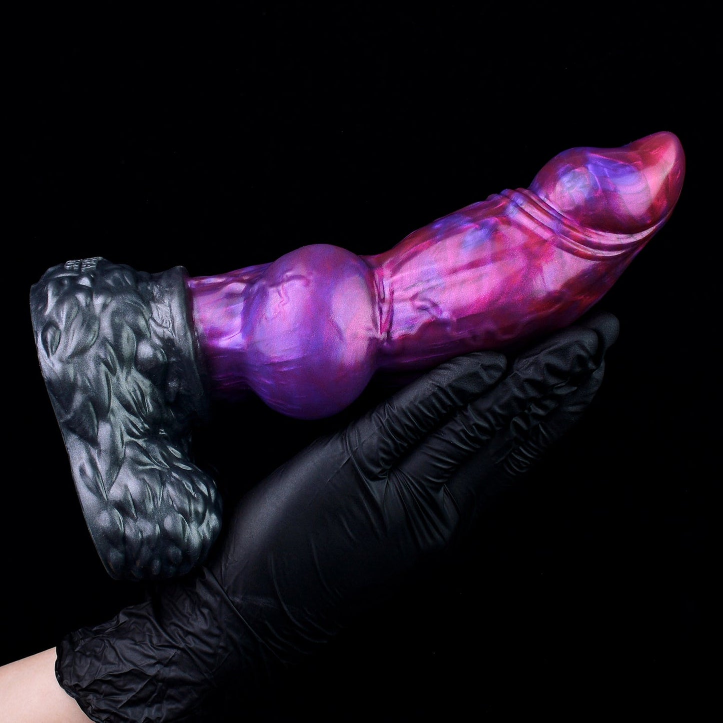 Lycan the Werewolf dildo, Adrenaline colorway, held in a gloved hand showing the full length of the shaft