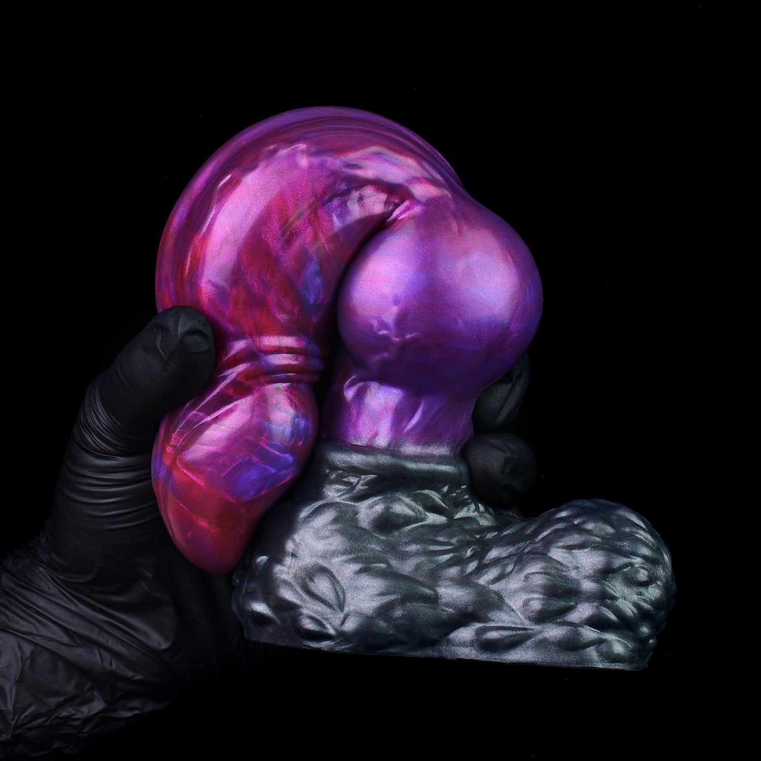 Lycan the Werewolf dildo, Adrenaline colorway, gloved hand gripping the pronounced canine knot