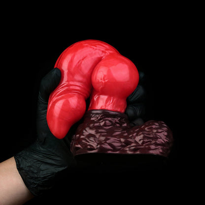 Lycan the Werewolf dildo, Furnace colorway, gloved hand gripping the pronounced canine knot