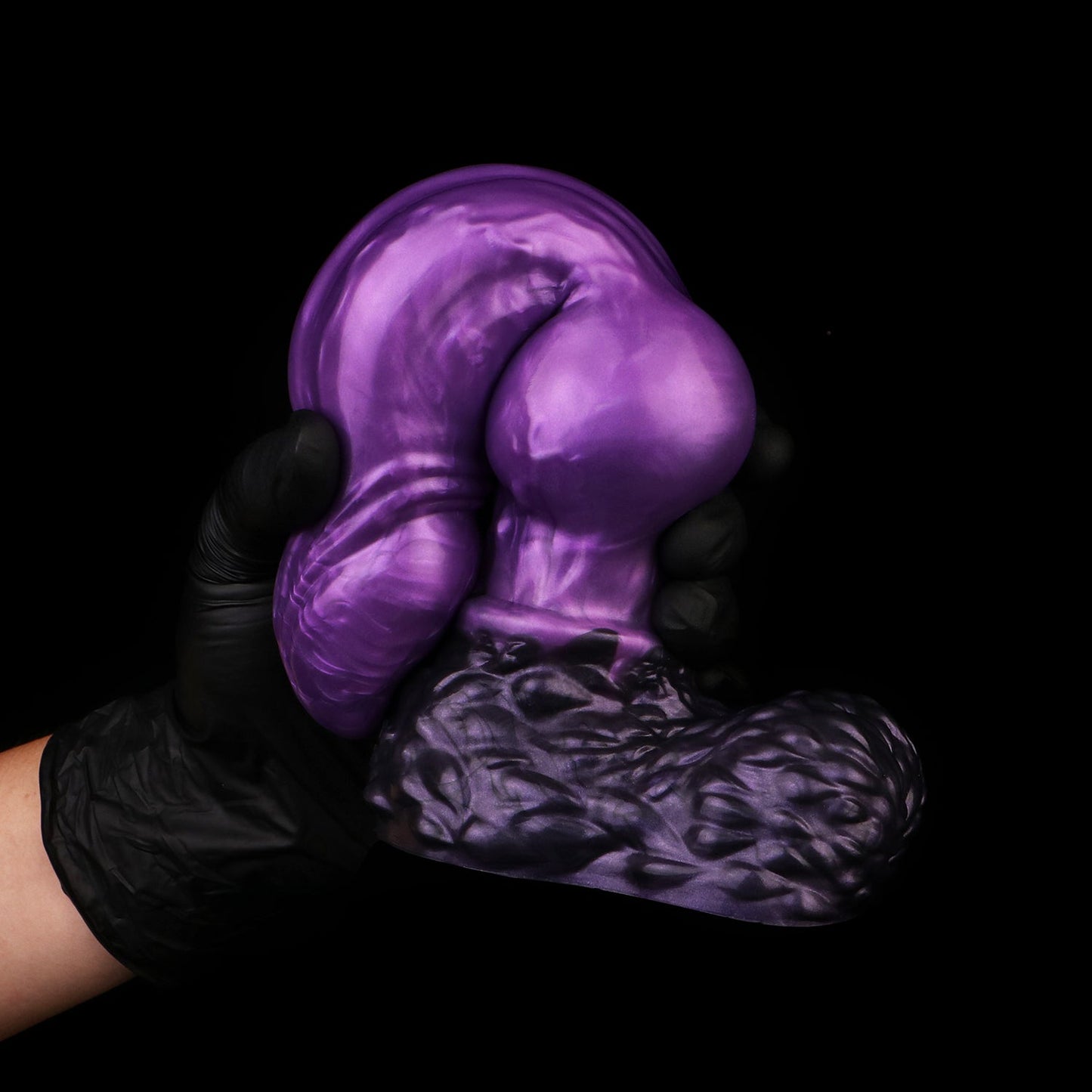 Lycan the Werewolf dildo, Grape colorway, gloved hand gripping the pronounced canine knot