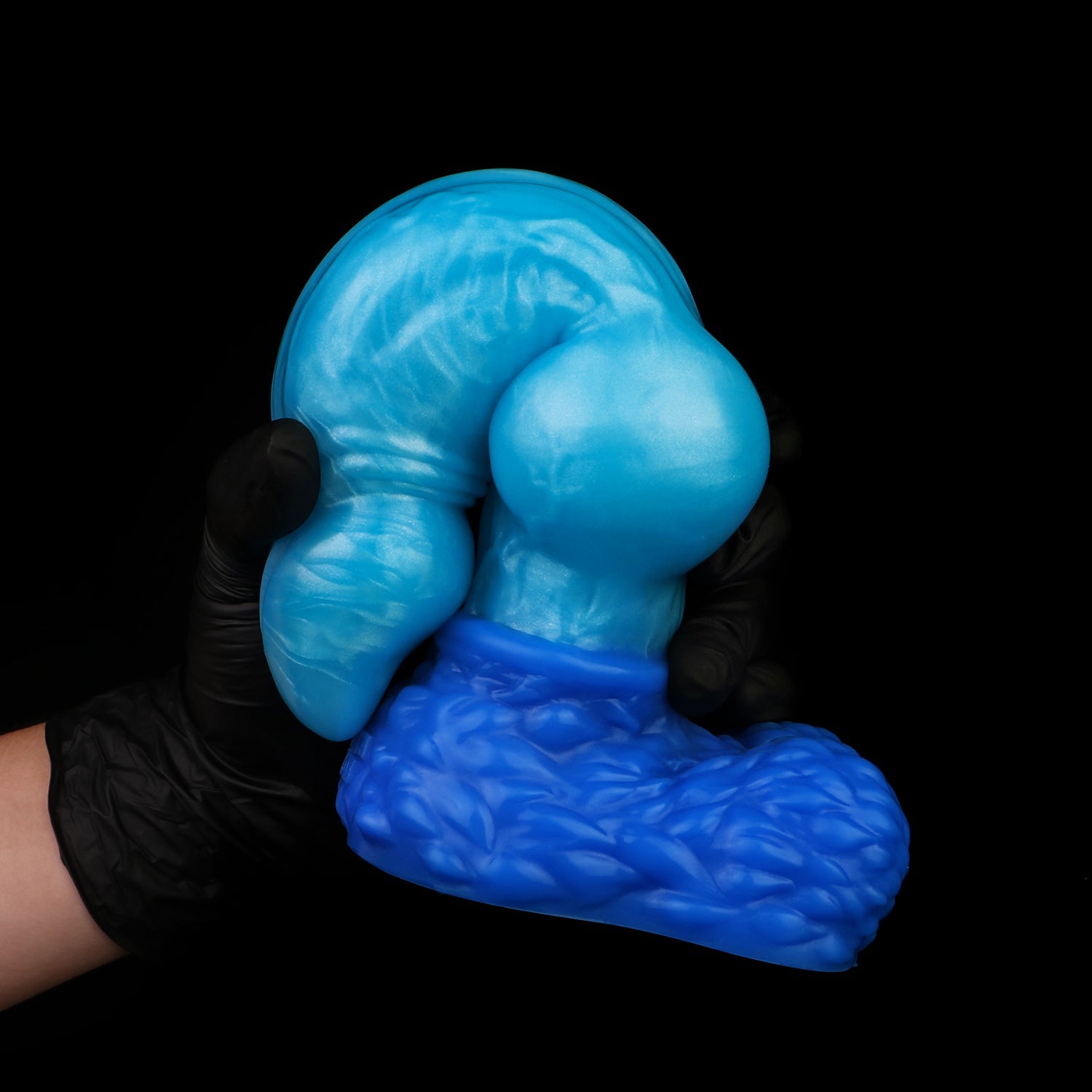 Lycan the Werewolf dildo, Shock colorway, gloved hand gripping the pronounced canine knot