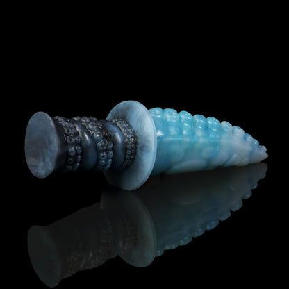 Moros the Deep One dildo, Abyss colorway, lying on its side in full profile with the handle to the left