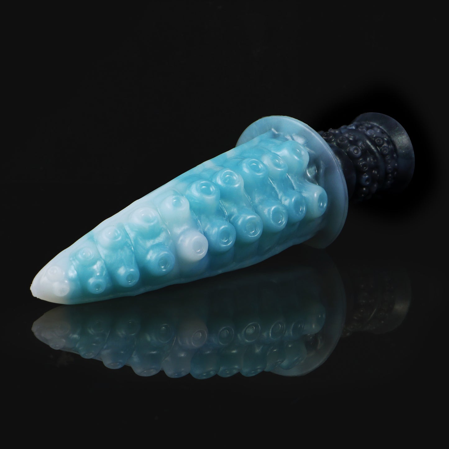 Moros the Deep One dildo, Abyss colorway, lying at an angle showing the sucker texture across the tapered tentacle