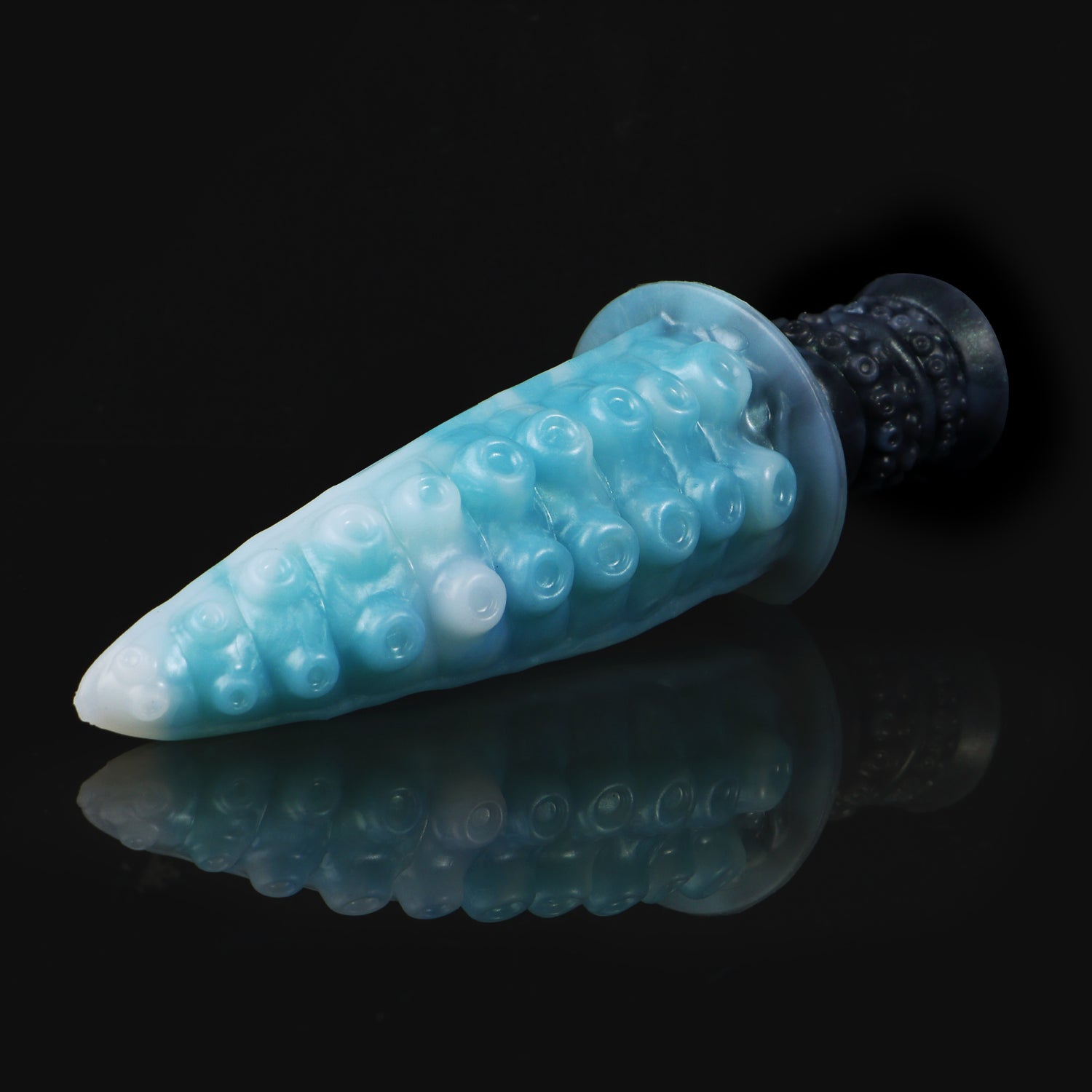 Moros the Deep One dildo, Abyss colorway, lying at an angle showing the sucker texture across the tapered tentacle