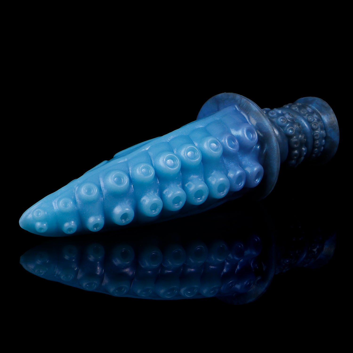 Moros the Deep One dildo, Arctic colorway, lying on its side in full profile showing the rows of suckers