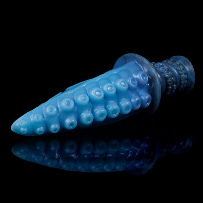 Moros the Deep One dildo, Arctic colorway, lying on its side in full profile showing the rows of suckers