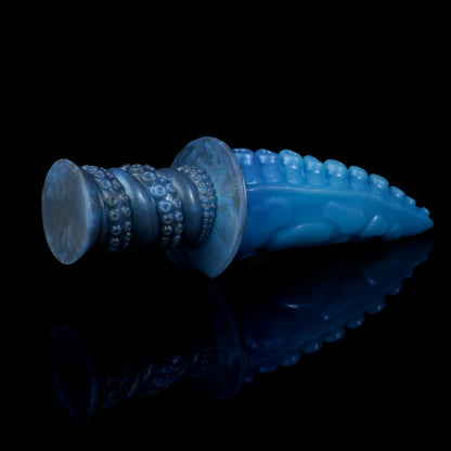 Moros the Deep One dildo, Arctic colorway, angled view with the ergonomic ribbed handle in the foreground