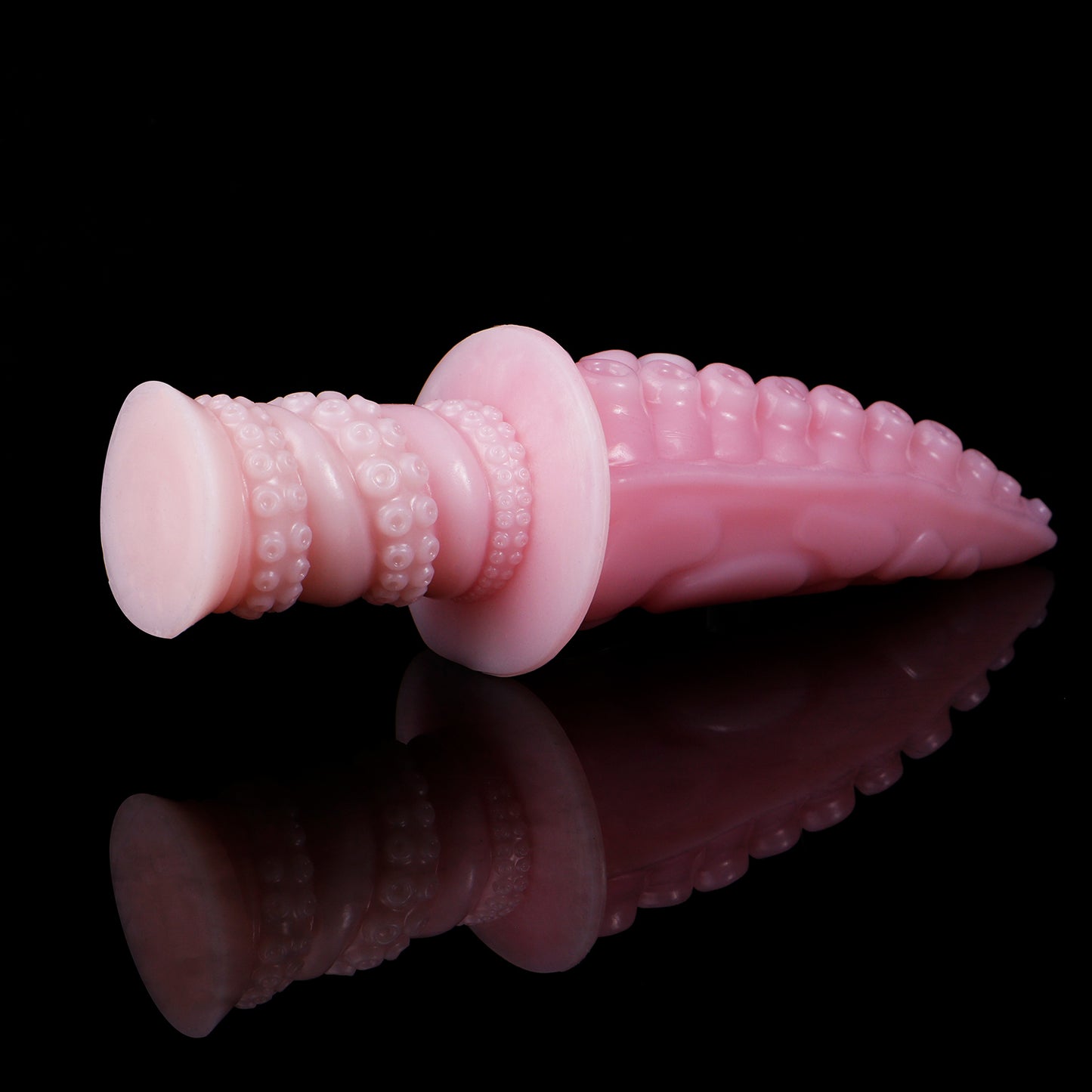 Moros the Deep One dildo, Fairy Floss colorway, angled view with the ergonomic ribbed handle in the foreground
