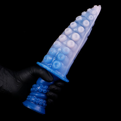 Moros the Deep One dildo, Flux colorway, held by the ergonomic handle in a gloved hand