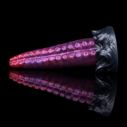 Tendrul the Tentacle dildo, Adrenaline colorway, lying on its side with the whirlpool-wave base to the right