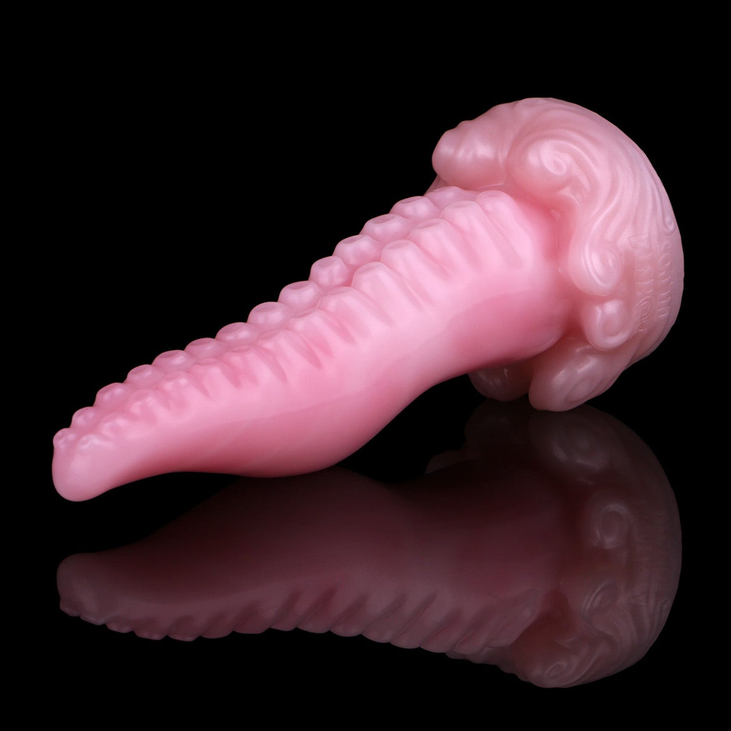Tendrul the Tentacle dildo, Fairy Floss colorway, lying at an angle showing the suckers and sculpted whirlpool base
