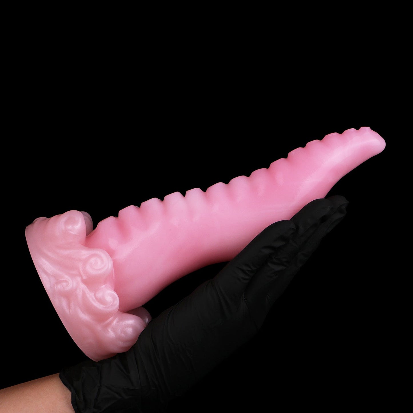 Tendrul the Tentacle dildo, Fairy Floss colorway, held in a gloved hand showing the full length of the tentacle
